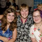 three women friends sitting together smiling