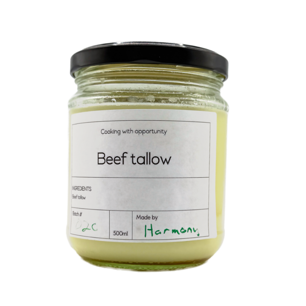 Glass jar of beef tallow with a black lid and product label, showcasing a product created through the Pathways to Plate program.