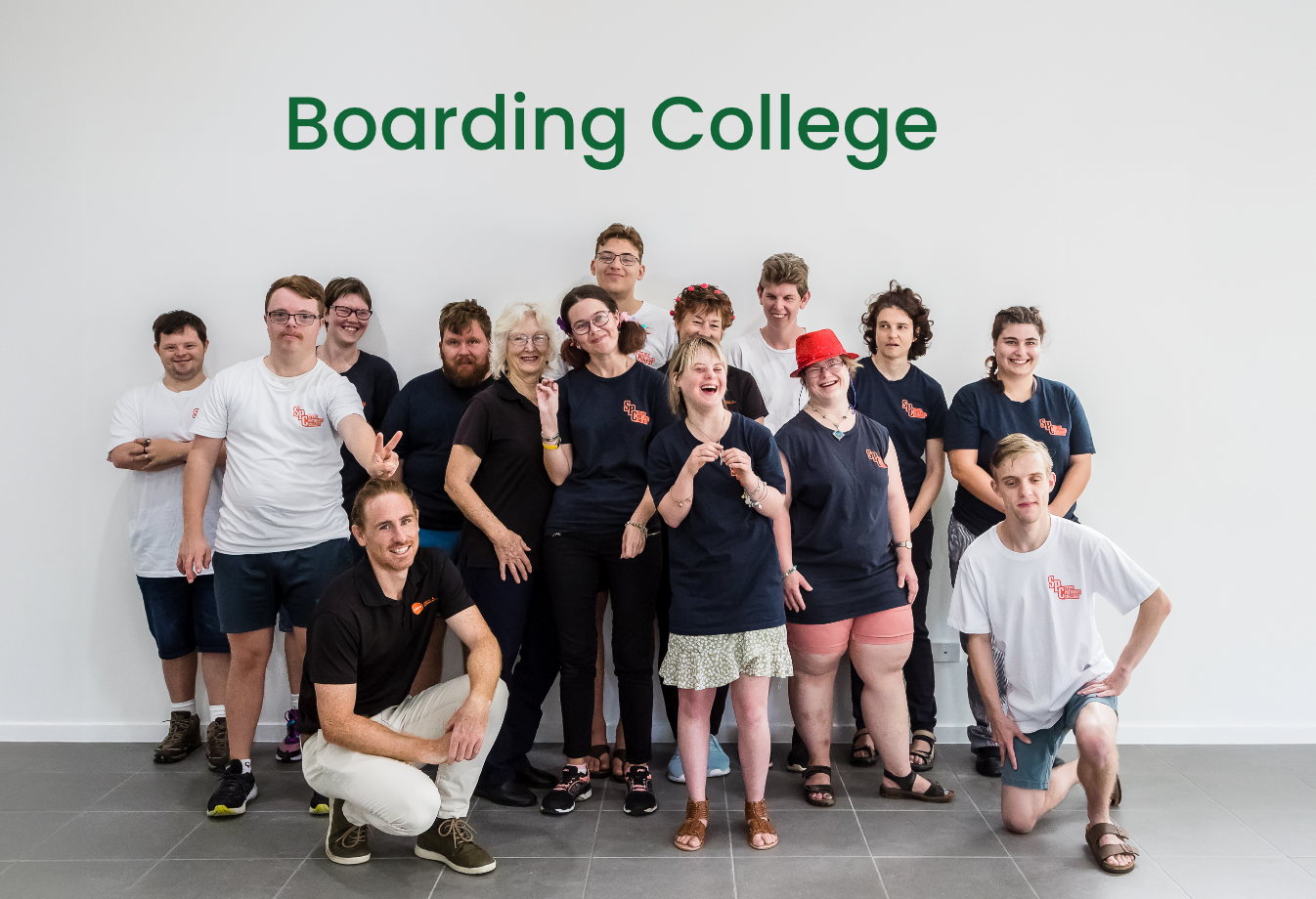 A group of STEPS Pathways College participants and staff smiling and enjoying themselves with the text 'Boarding College' overhead