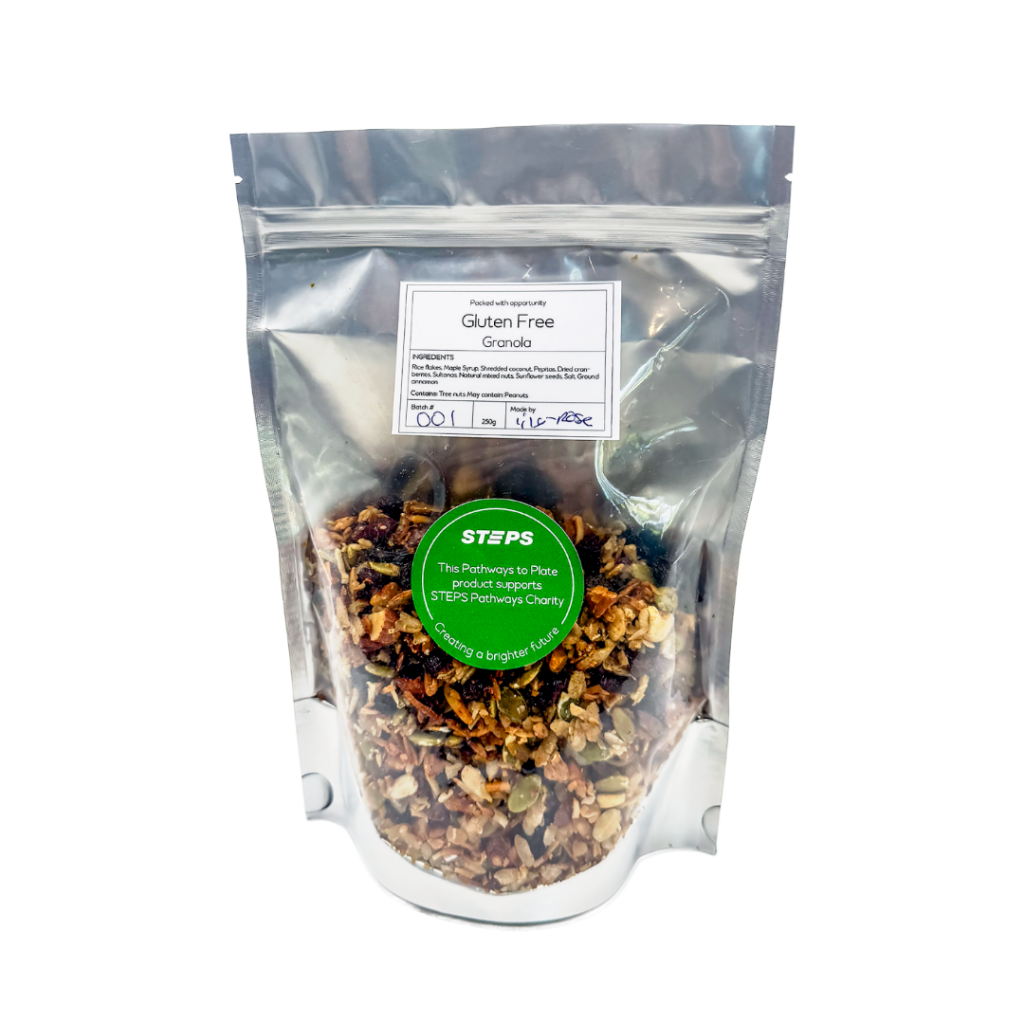 Stand-up pouch of gluten-free granola with a clear window and Pathways to Plate branding, displaying a mix of oats, seeds and dried fruit.
