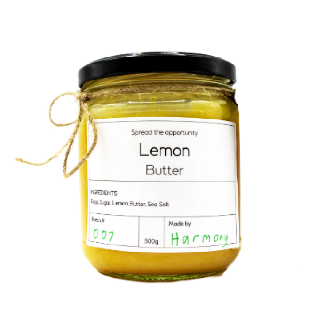 Glass jar of lemon butter with a black lid and rustic twine, showcasing a spread created through the Pathways to Plate program.