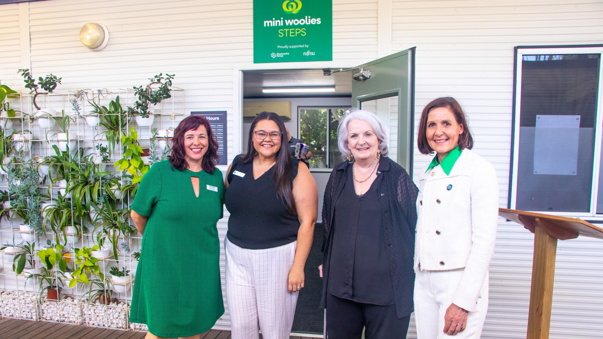 STEPS Pathways Charity Manager Katrina May, Head of Operations for STEPS Social Business Tiah Hardy, and STEPS Managing Director Carmel Crouch stand outside Mini Woolies classroom, smiling.