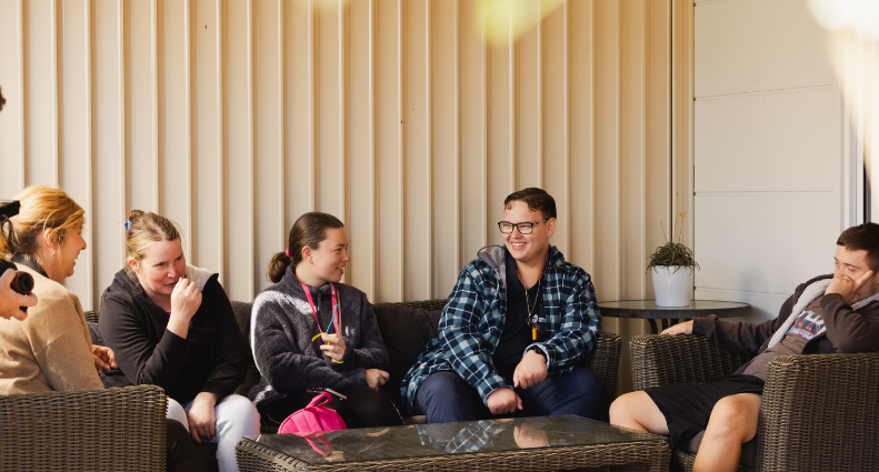 STEPS Pathways College boarding students sitting outside their accommodation socialising.
