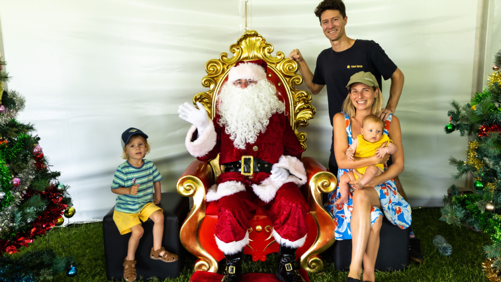 Family with two young children visiting Santa at the STEPS Autism Treehouse Christmas Party