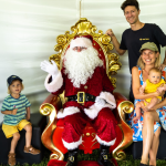 Family with two young children visiting Santa at the STEPS Autism Treehouse Christmas Party