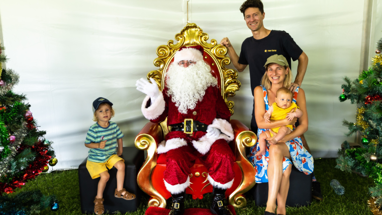Family with two young children visiting Santa at the STEPS Autism Treehouse Christmas Party